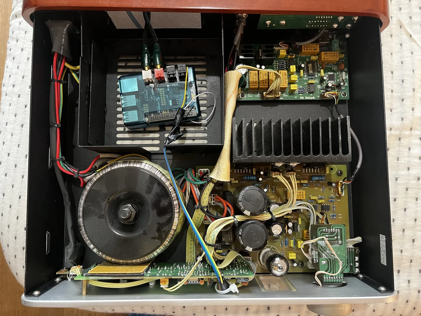 The Pi 3 and HiFiBerry DAC mounted inside the Decco's housing, beside the transformer and the tube